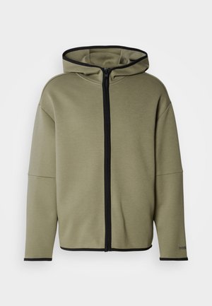Groene hoodie met rits en capuchon, afgewerkt met zwarte details. Heeft een losse pasvorm en grote voorkantzakken. Gemaakt van zachte, gestructureerde stof.