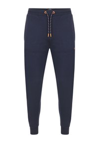 Pantalon de survêtement bleu marine fuselé avec cordon de serrage à accents orange, taille élastique, poches latérales et chevilles élastiquées.