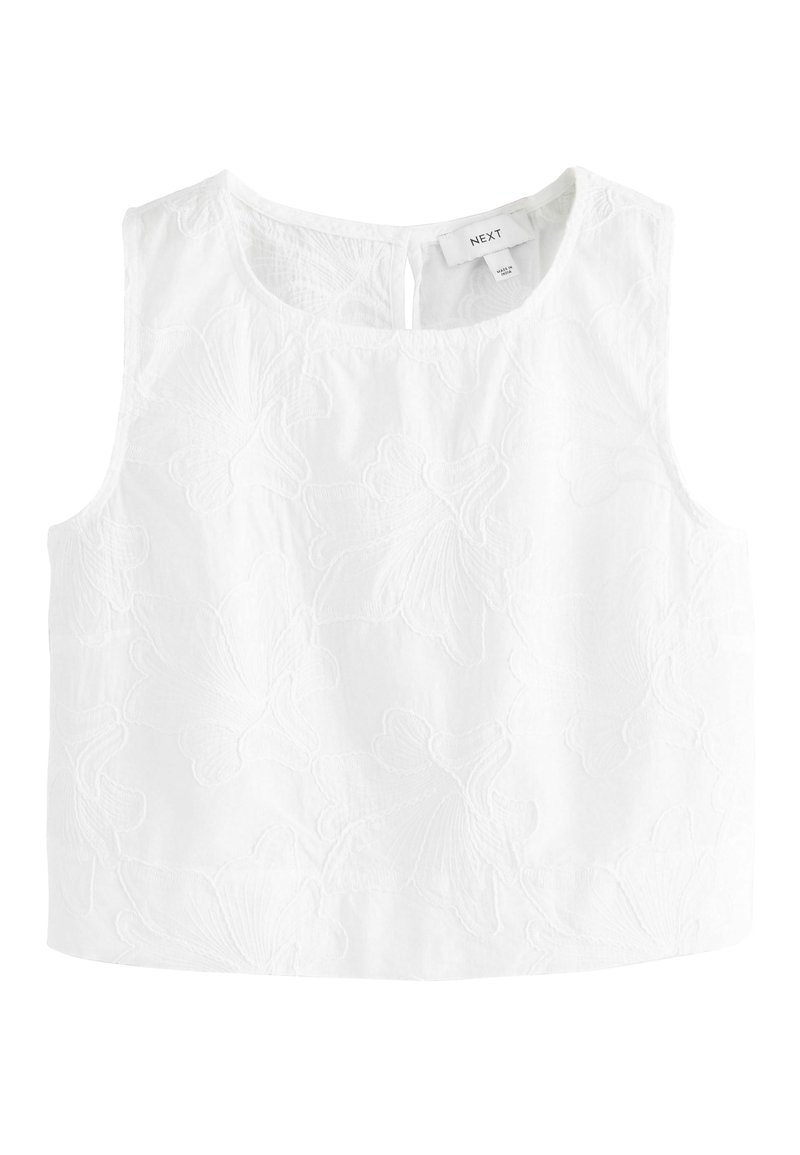 Haut sans manches blanc avec broderie florale, col rond et fermeture à bouton à l'arrière. Fabriqué en tissu léger.