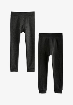 Twee paar thermoleggings in donkere tinten. Eén heeft een geribbeld patroon; beide hebben elastische taillebanden en aangesloten boorden bij de enkels.