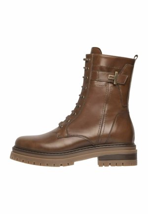 Bottines en cuir marron à lacets avec semelle en caoutchouc épaisse et détail de boucle sur le côté, conçues pour un usage décontracté et robuste.