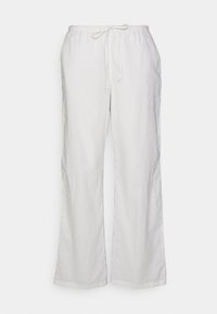 Pantalons en lin blancs, coupe ample, avec taille élastique et cordon de serrage, jambe droite, présentés sur fond uni.