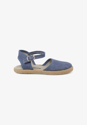 Blue canvas sandal with an ankle strap, woven jute sole, and a rounded toe. Features a buckle closure and a striped interior lining.