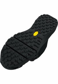 Black rubber shoe sole featuring deep, multidirectional traction lugs. Notable yellow Vibram logo located in the center.