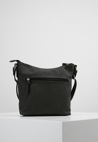 Sac bandoulière en cuir noir avec une finition texturée, fermeture éclair sur le dessus et poche zippée extérieure. Bandoulière réglable incluse.