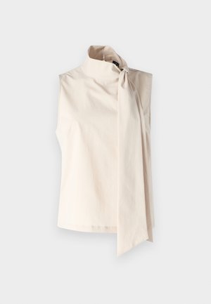 Kremowa bezrękawnik z wysokim kołnierzem i dużą kokardą po boku. Wykonana z gładkiego, lekkiego materiału o prostym wzorze.