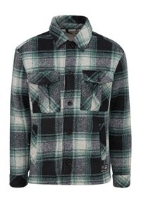 Veste boutonnée à carreaux verts, noirs et blancs avec deux poches à rabat sur la poitrine et des poches latérales, dotée d'un col et de manches longues.