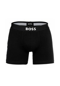 Svarta kalsonger i mjuk bomull med en vit logotyp på midjebandet. Designen har en figurnära passform och elastiskt stretchmaterial.