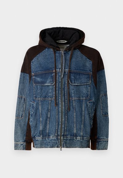 Denim jacket with a dark brown hood, featuring large front pockets, zip closure, contrasting brown sleeves, and a textured design.