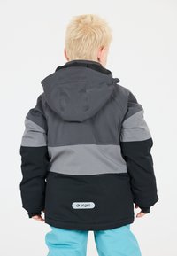Sort, grå og lysegrå polstret jakke med hætte; har et logo-patch "ZIGZAG" på ryggen og en tætsiddende design.