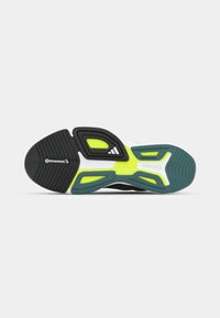 Shoe sole with a black rubber base, green and yellow accents, and a patterned tread. Features a Continental logo and curved design.