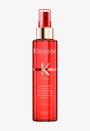 Red spray bottle of Kérastase Soleil Huile Sirène beach bi-phase oil mist for sun-exposed hair, 150 ml, with gold and red spray cap.