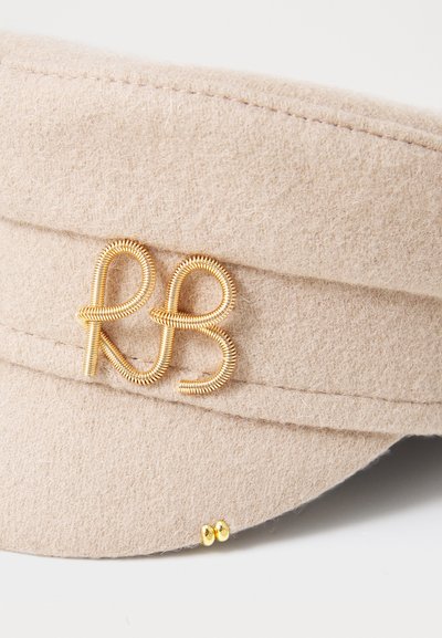 Beez villane pehme müts, millel on kuldne traadist monogramm "RB" ja kaks väikest kuldset nööpi ääre servas.