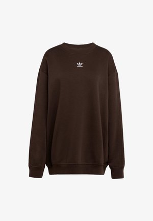 Brązowa bluza z okrągłym dekoltem, wykonana z miękkiego materiału. Posiada małe białe logo Adidas na piersi. Luźny krój z ściągaczami przy mankietach i u dołu.