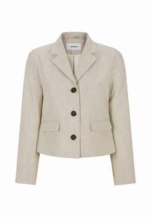 Smėlio spalvos, tekstūruotas švarkas su prigludusia forma, su įpjautomis atlapomis ir trimis tamsiais mygtukais. Turi du priekinės kišenes. Struktūruotas, individualiai pritaikytas dizainas.