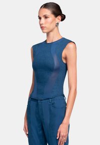 Denim bodysuit with sheer side panels, fitted design, sleeveless style, deep blue color, and smooth texture. Suitable for layering or standalone wear.