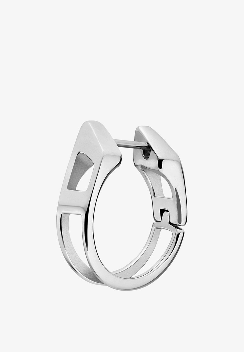 Boucle d'oreille en argent en forme de créole avec un design géométrique, comprenant des découpes et une finition polie. Le fermoir est à charnière pour fixer.