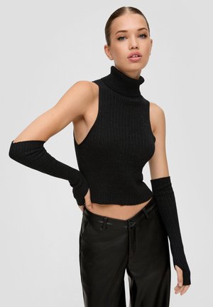 Black ribbed turtleneck top with cut-out shoulders and long sleeves. Paired with high-waisted black leather pants.