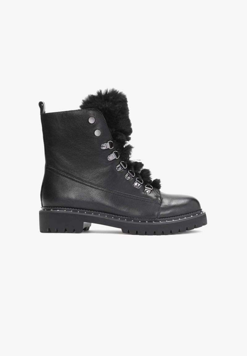 Black leather ankle boots with faux fur trim, silver hardware, and a rugged sole. Features lace-up design and round toe with textured surface.