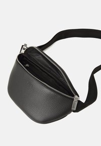 Borsa a tracolla nera in pelle con superficie texturizzata, forma arrotondata, cerniera argentata e tracolla nera. L'interno presenta un compartimento foderato.