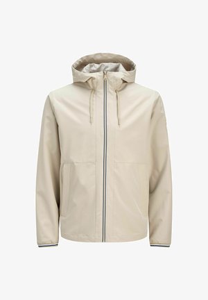 Lys beige, hettejakke med glidelås foran. Har to store lommer og en kontrasterende marineblå stripe ned midten. Glatt tekstur.