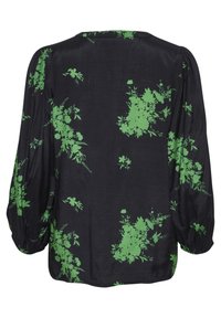 Blouse noire à imprimé floral vert, avec manches longues bouffantes et encolure ronde. Texture lisse et coupe décontractée.