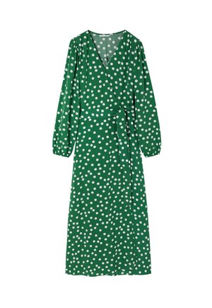 Zaļu audumu apģērbs ar baltām pkt, garām piedurknēm, V veida kaklu un atbilstošu jostu jostasvietā.