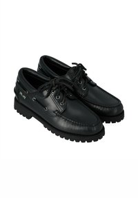 Chaussures bateau en cuir noir à bout rond, design à lacets et semelle en caoutchouc avec rainures moulées. Détails de couture le long des côtés.