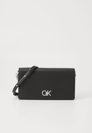 Black leather crossbody bag with silver hardware. Features a detachable strap and embossed logo on the front. Flat design, smooth texture.