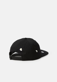 Black cap with a curved brim, featuring embroidered egg motifs. Made of fabric with a structured design, adjustable strap at the back.