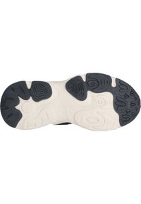 Semelle en caoutchouc avec un motif texturé noir et blanc, comportant des rainures et des formes variées pour une traction et une adhérence optimales.