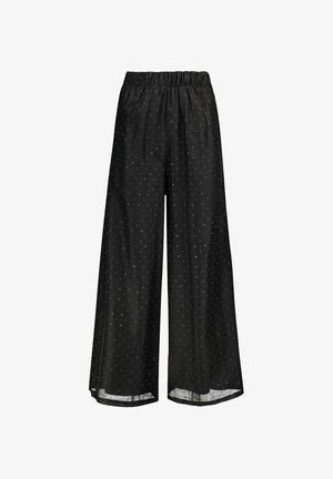 Pantalon noir à jambes larges avec taille élastique et petits pois blancs, fabriqué en tissu léger et semi-transparent.