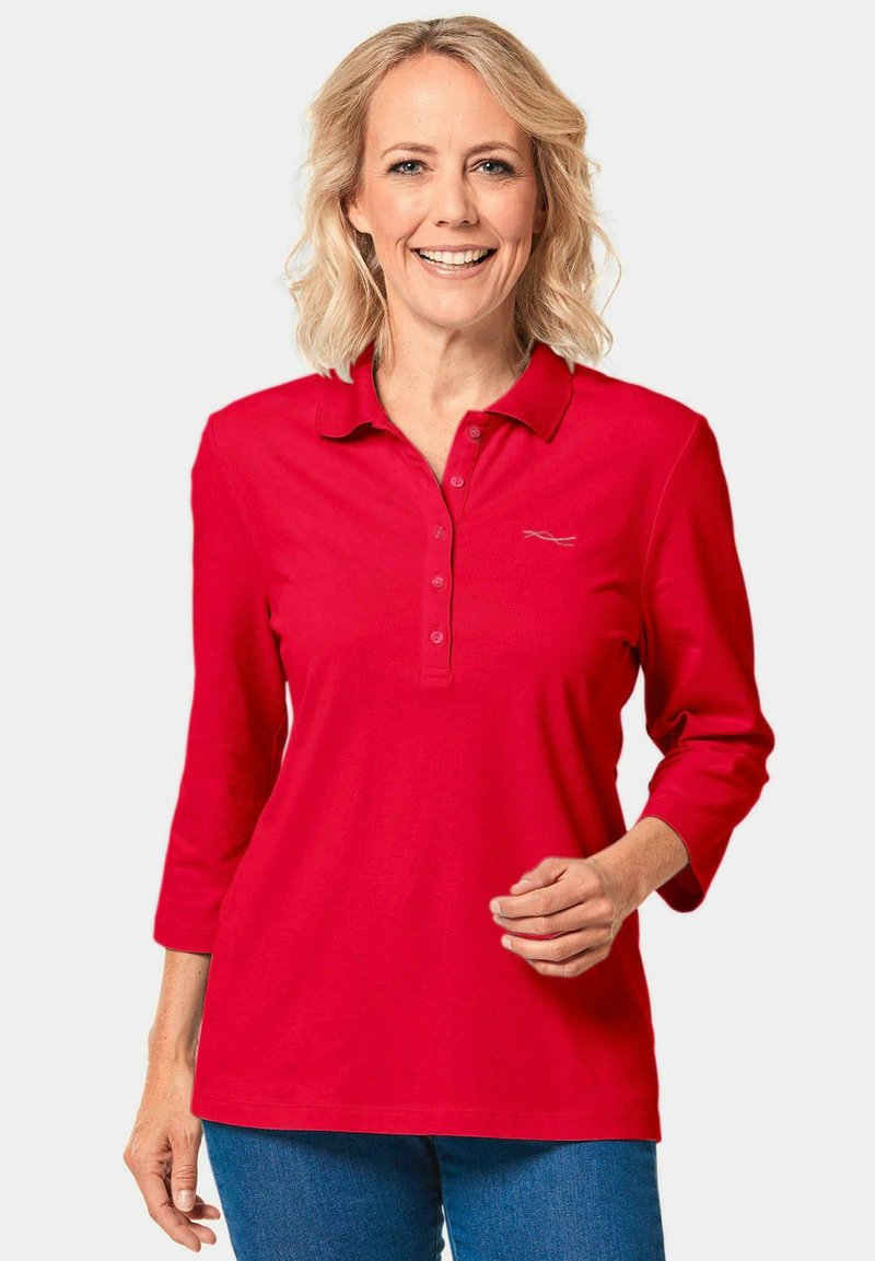 Rode polo shirt met lange mouwen, kraag en knoopsluiting, met een subtiele logodetail. Zachte katoenstof, relaxte pasvorm.