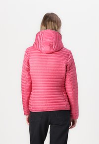 Padded pink jacket with horizontal quilting, a hood, and a smooth texture. Features a fitted silhouette and elastic cuffs.