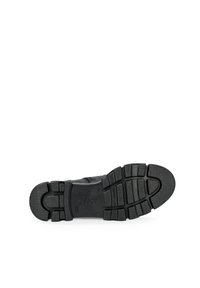Black rubber shoe sole featuring a patterned tread, rectangular grooves, and the "Gabor" logo embossed near the heel.