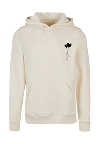 Cream-colored hoodie with a front pocket. Features a black graphic of a person holding three heart-shaped balloons on the left chest area.