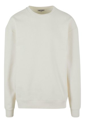 Svetlo bež pulover s krojem okroglega vratu, izdelan iz mehkega bombažnega materiala. Ima rebraste manšete in rob, z spušenimi shoulder seams za sproščen kroj.