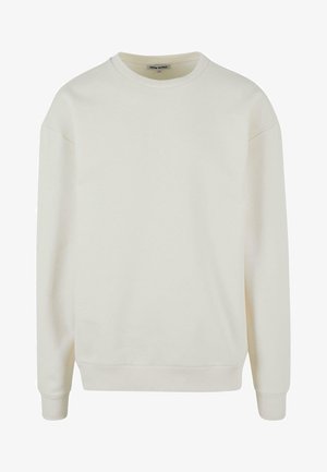 Világos bézs színű, crewneck pulóver, amely puha pamut keverékből készült. Különleges jellemzői közé tartozik a bordás mandzsetta és alj, valamint a leengedett vállvarrások, amelyek laza illeszkedést biztosítanak.