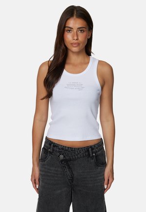 Biały prążkowany top na ramiączkach z okrągłym dekoltem, ozdobiony szarym nadrukiem w swobodnej czcionce. Połączony z ciemnoszarymi, poszarpanymi spodniami z szerokimi nogawkami.