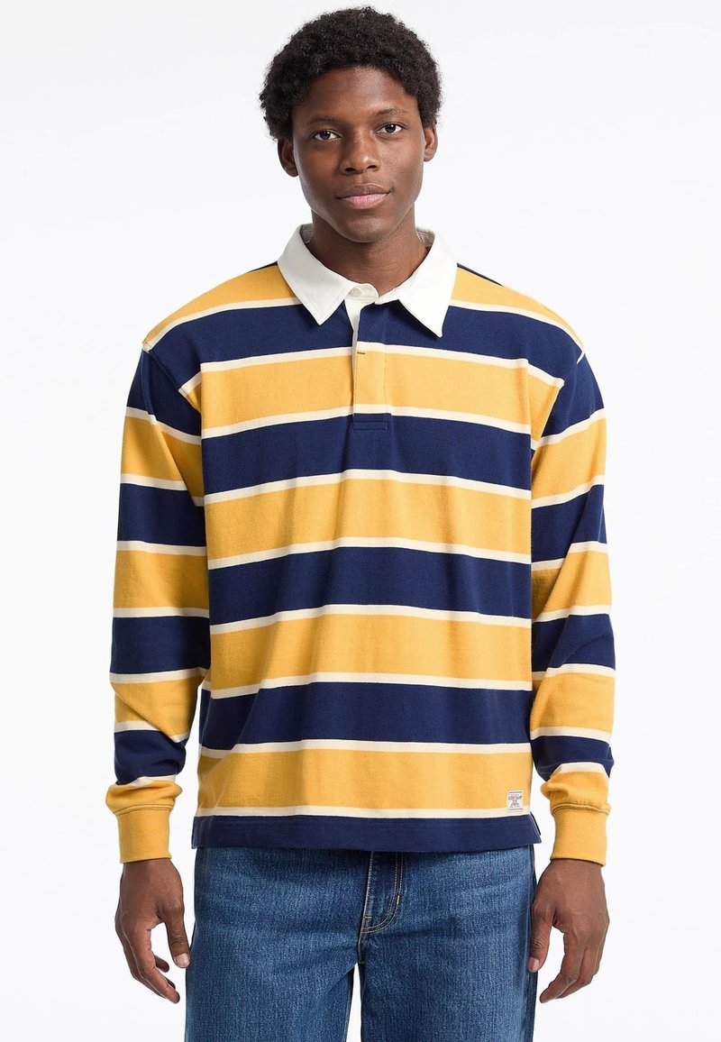 Long-sleeve polo shirt featuring horizontal navy blue, yellow, and white stripes, with a white collar and cotton fabric. Casual fit design.