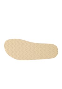 Soletta per scarpe con una base in gomma beige, caratterizzata da un motivo a onde per la trazione. Texture liscia, forma sagomata, progettata per il comfort.