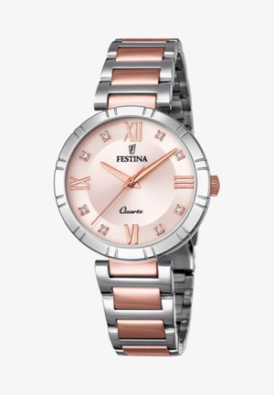 Festina kvarca pulkstenis ar apaļu sudraba korpusu, rozā zelta akcentiem un gaiši rozā ciparnīcu. Tajā ir romiešu cipari un nerūsējošā tērauda siksna.