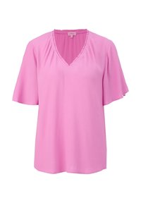 Blouse rose à manches courtes avec col en V et bordure à volants le long de l'encolure, en tissu léger.