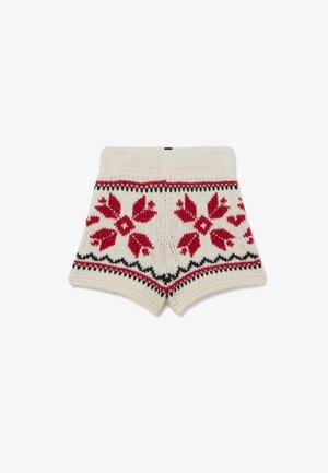 Knitted shorts in cream with red floral patterns, black accents, and a ribbed waistband. Features a cozy texture and classic design.