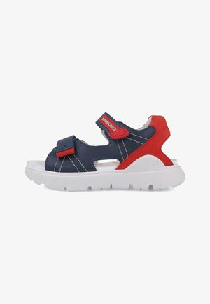 Sandalias sintéticas de color azul marino y rojo con correas de velcro, suela de goma blanca y detalles cortados en los laterales para ventilación.