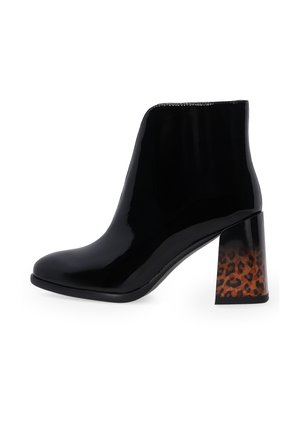 Black patent leather ankle boot with a block heel featuring a brown and black leopard print pattern.