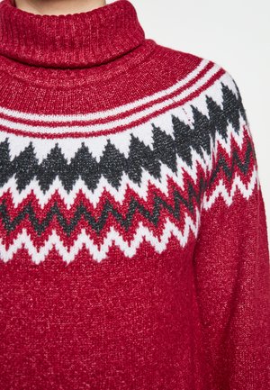 Roter gestrickter Pullover mit hohem Kragen, Zickzackmustern in Rot, Weiß und Schwarz auf der Brust. Weiche Textur mit Rippakzenten.