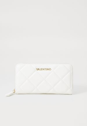 White quilted Valentino zip-around wallet with gold logo and matching white zipper pull on plain background.