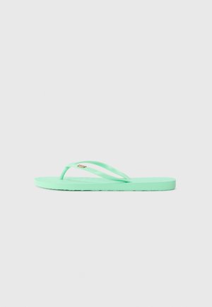 Mėtų žalios spalvos flip-flop šlepetės, pagamintos iš gumos, su plonomis dirželis, tekstūruotu padu ir subtiliu logotipo akcentu ant dirželio. Plokščias padas.