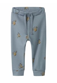 Helle blaue Sweatpants mit elastischem Bund, verziert mit einem wiederholten Muster aus kleinen Flugzeugen und Bärenpiloten. Aus weichem, dehnbarem Baumwollmaterial.